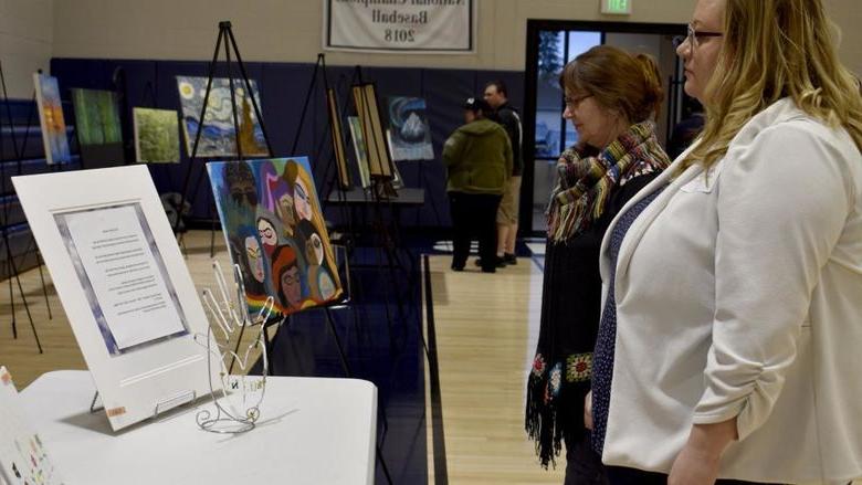 Attendees view some of the artwork submitted at the annual campus and community art show, hosted by the IDREAM Team at 365英国上市杜波依斯分校.